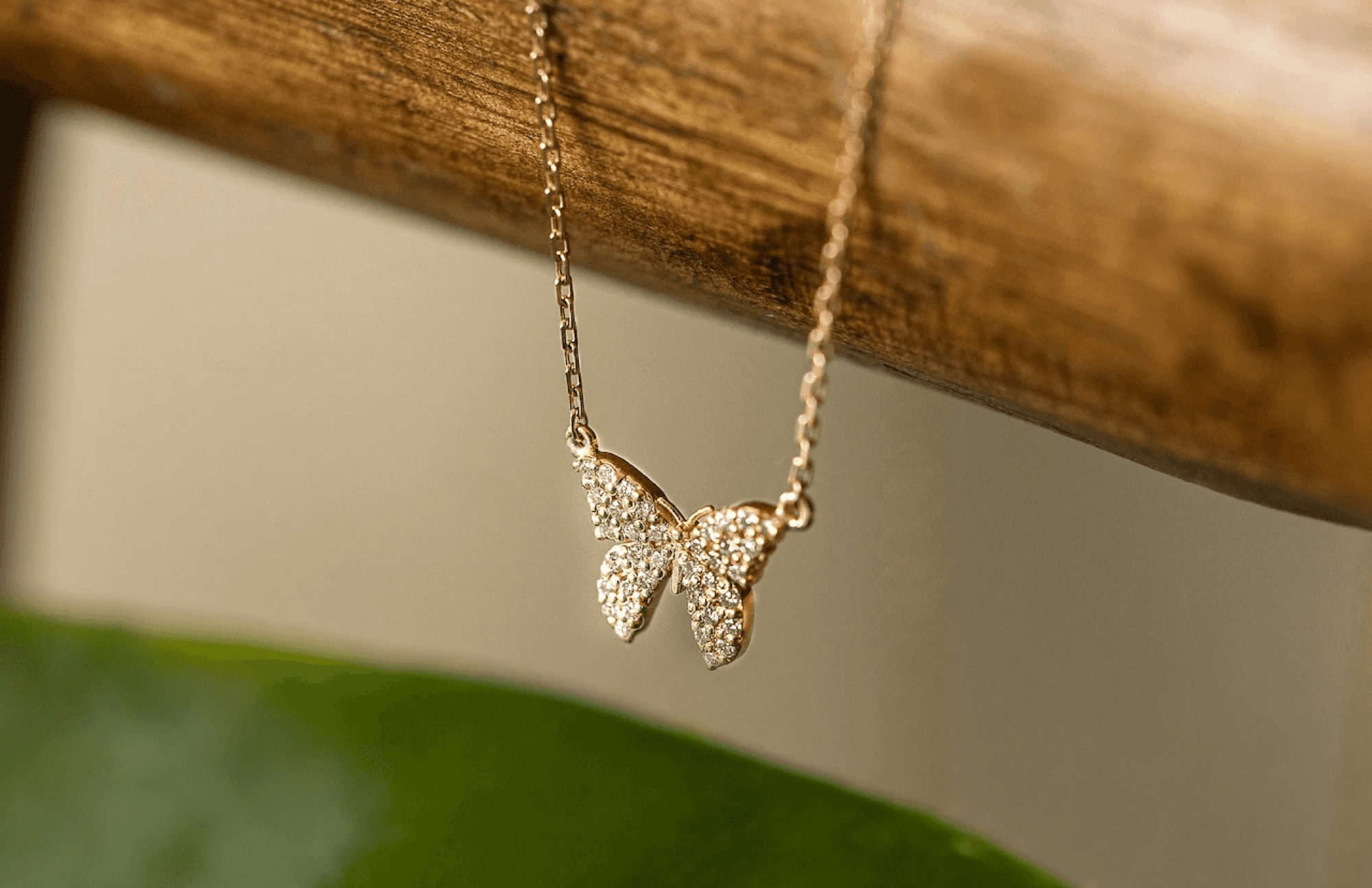 Small butterfly pendant suspended from wood