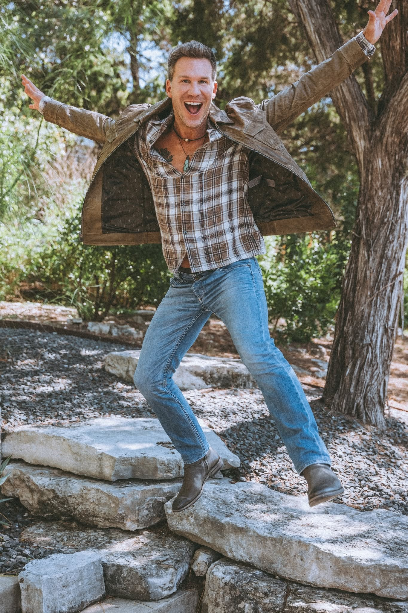 Judd Shaw outdoors with arms outstretched